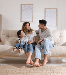 A family of three sitting on a couch having a conversation about home security measures, home improvement ideas, and home value.