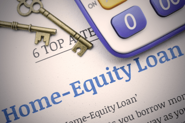 Home equity loan paperwork with keys and a calculator